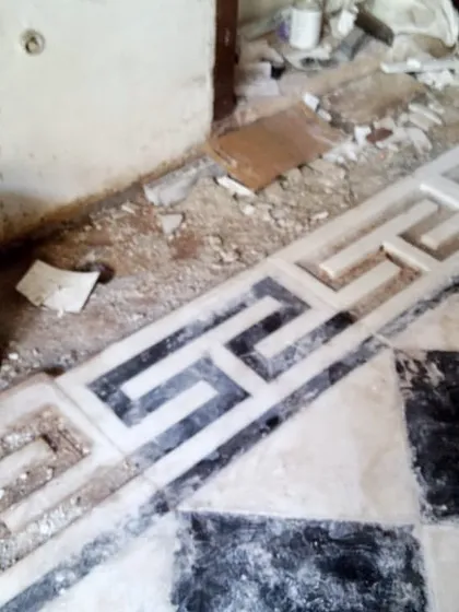 A close-up of the intricate marble flooring border being restored in the haveli. We took great care to salvage and repair original elements, combining traditional craftsmanship with modern restoration techniques.