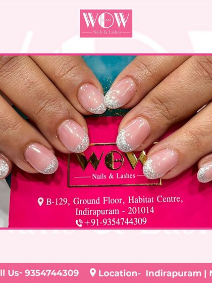 A classic glitter French manicure on short, rounded nails. The sparkling silver tips add a fun and festive touch to this timeless style.