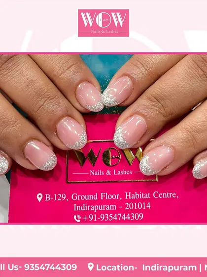 A classic glitter French manicure on short, rounded nails. The sparkling silver tips add a fun and festive touch to this timeless style.