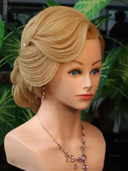 A front view of the rose bun hairstyle, showing the soft, flattering front variation that complements the intricate bun at the back.