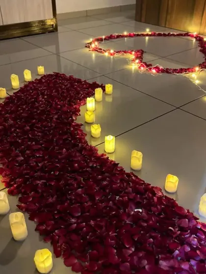 A beautiful pathway of rose petals and flameless candles leading to a heart shape on the floor. This is a perfect way to lead your loved one to their surprise.