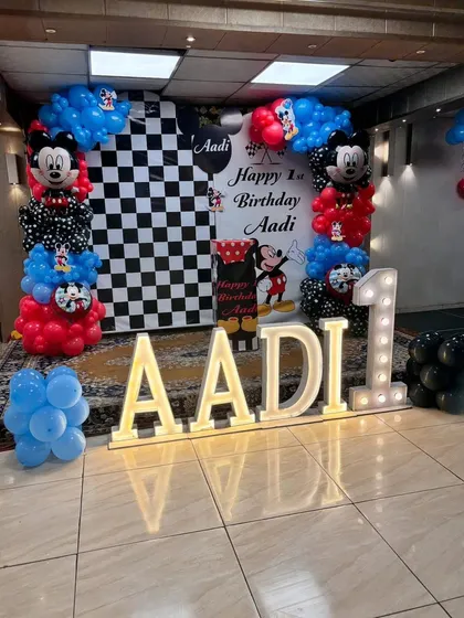 Another angle of the Mickey Mouse birthday setup, showing the full name in light-up letters and the themed backdrop.