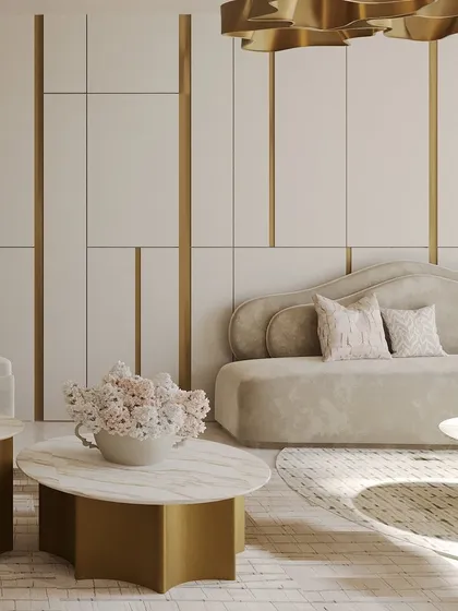 A close-up view of the soft, inviting textures and forms. The marble coffee table with a gold base adds a touch of opulence, while the plush sofa and fresh flowers create a sense of comfort and life.