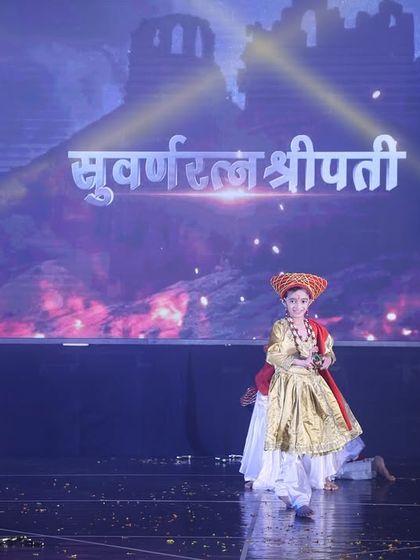 The solo entrance of the main character in our "Tanaji" act. The stage is set with dramatic lighting and background visuals to establish the historical setting.