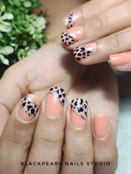 A stylish safari on your nails, this design pairs a nude polish with an animal print accent. It's a chic and trendy way to incorporate a wild pattern into your look.
