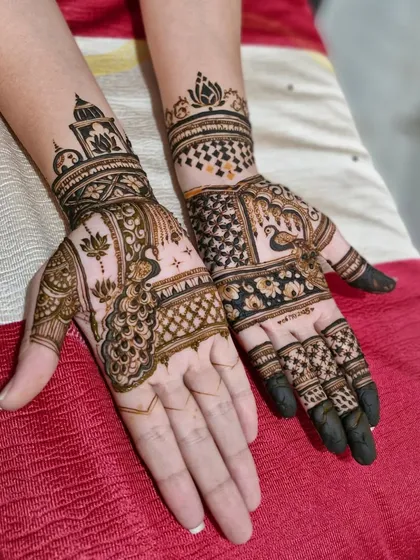 A lovely combination of traditional motifs, with a peacock on one hand and a lotus with temple architecture on the other.
