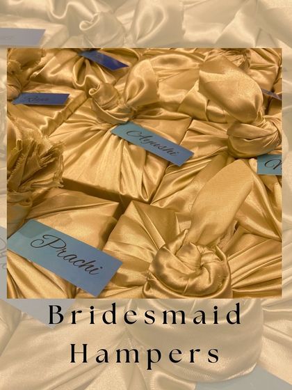A collection of our fabric wrapped bridesmaid hampers, showcasing the beautiful texture and personalized tags that make each gift unique.