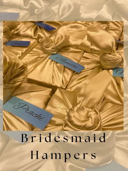 A collection of our fabric wrapped bridesmaid hampers, showcasing the beautiful texture and personalized tags that make each gift unique.
