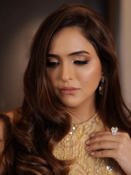 A downward glance to showcase the beautiful, shimmering gold eyeshadow. This look is perfect for a corporate event or party, adding a touch of glamour that is still professional and polished.
