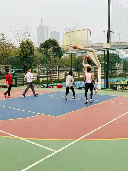 A player attempts a layup in traffic, showing courage and skill.