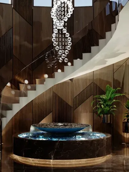 A beautiful stairway enhances the grandeur of any space. This helical staircase, with its cascading crystal chandelier and intricate wood-paneled wall, serves as a functional sculpture, connecting floors while adding a significant element of architectural beauty to this Agra residence.