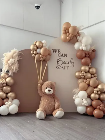 "We Can Bearly Wait" for this adorable teddy bear themed baby shower. The neutral, earthy tones of the balloons, pampas grass, and modern backdrops create a trendy and heartwarming theme.