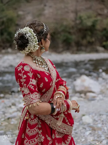 A beautiful detail shot of the bride's intricate hairstyle, adorned with fresh flowers.