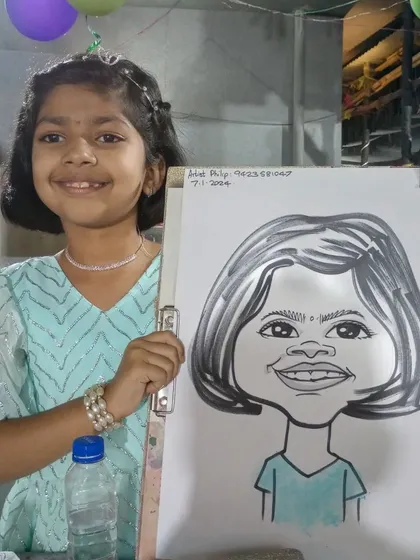 A smiling girl with her finished drawing. It's a wonderful souvenir to take home.