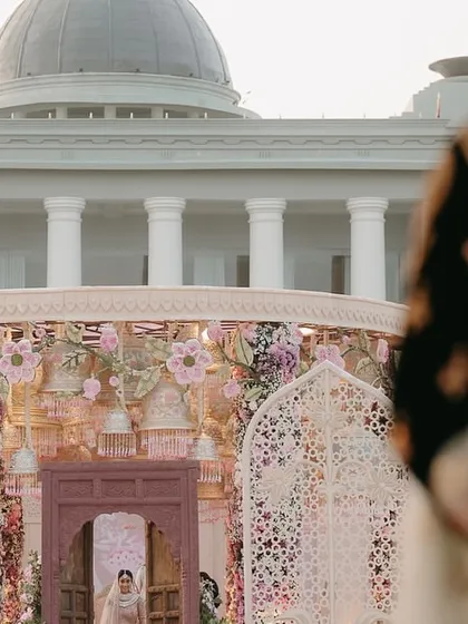 The moment the groom sees his bride for the first time, framed by the intricate architecture of the mandap at Raffles Udaipur. We meticulously plan these emotional highlights, from the bridal entry path to the decor that frames the view.