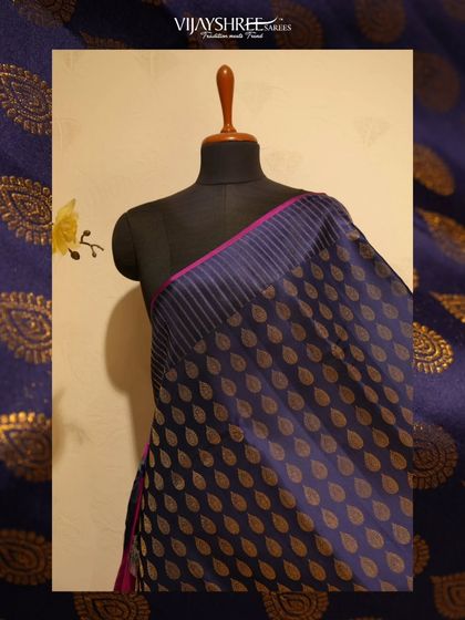 A deep blue Kanjivaram with all-over leaf buttas in gold zari, a sophisticated choice for evening festivities.