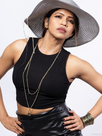 A close-up of the model with the hat, focusing on her confident expression.