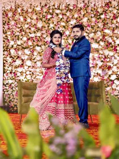 A classic wedding reception with a beautiful floral wall backdrop. We created this dense wall of flowers to serve as an elegant and timeless setting for the couple's reception photos.