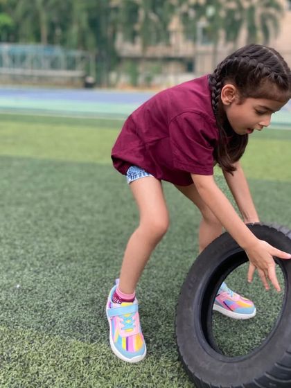 Building strength one tire flip at a time. This activity is a great way for kids to challenge their muscles in a fun and empowering way.