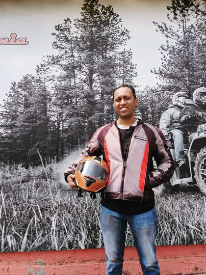 A happy rider who came all the way from Hyderabad, posing in front of our Dirt Mania mural. It shows that our adventures attract thrill-seekers from all over.