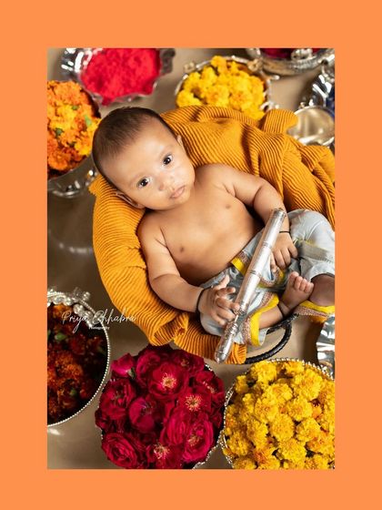 Celebrating Janmashtami with our own little Krishna. This festive setup features vibrant flowers and a tiny flute, perfect for capturing a special cultural moment.