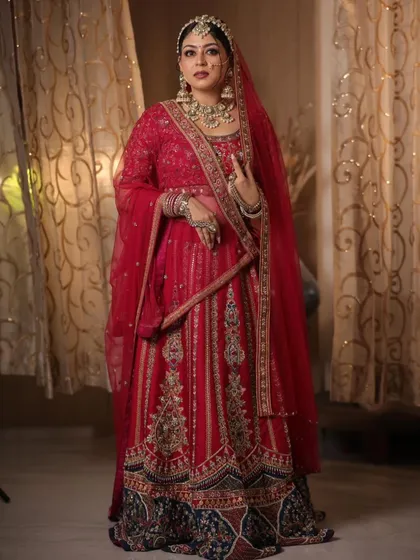 For the bride who loves rich, deep colors, this magnificent red and navy blue embroidered lehenga is a showstopper. Paired with a full bridal jewellery set, it’s a look of pure opulence.