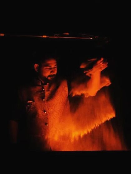 A dramatic shot of me in action, with the sand falling from my hand under the warm glow of the lightbox. This is where the story begins to take shape.