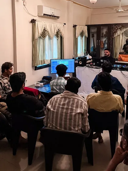 Students watching a demonstration of my production workflow on the main screen. We go deep into Ableton Live, exploring everything from basic navigation to complex sound design and arrangement.