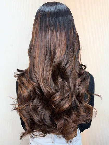 A final look at this gorgeous transformation. The rich brown base with subtle highlights and soft waves creates a look that is both glamorous and natural.