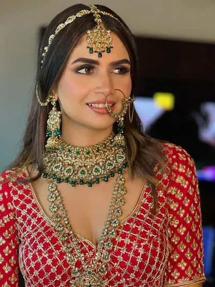 A confident pose from this stunning bride. The soft smokey eye and perfectly placed nath (nose ring) create a look of traditional elegance.