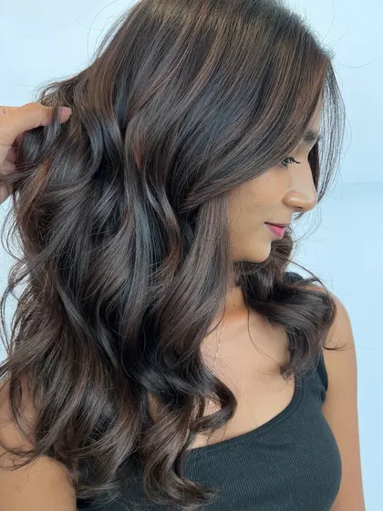 A side profile of the stunning Matryoshka balayage, showing how the colors are layered to create a seamless, multi-dimensional effect with beautiful waves.
