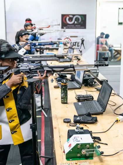 A shooter's perspective, aiming down the lane at the electronic target.