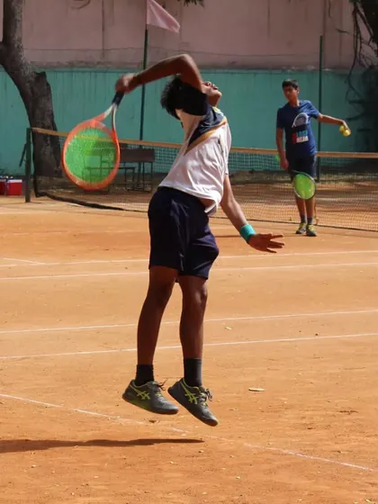 This is what the grind looks like. A junior player showing explosive power in his serve during a tense semi-final match. We create an environment where every player can push their limits.