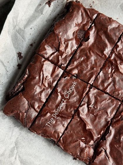 A full slab of my classic chocolate brownies, freshly baked and cut into squares. The shiny, crinkly top is consistent across the entire batch.