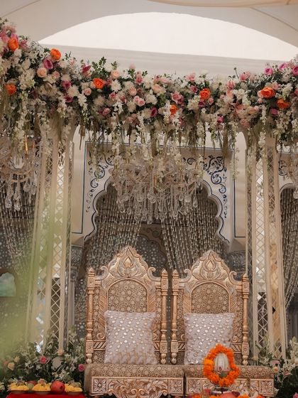 The mandap's design was a bridge between traditional and contemporary. The structure was inspired by Rajasthani architecture, while the pastel florals, hanging elements, and chandeliers added a soft, modern, English garden feel.
