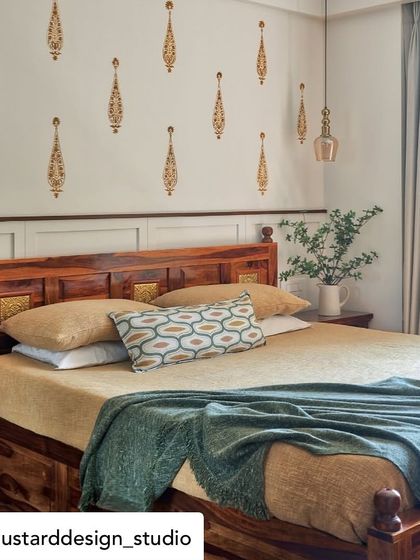 Delicate, hand-painted motifs create a subtle and elegant feature wall in this bedroom. The pattern adds a touch of traditional artistry without overwhelming the serene space.