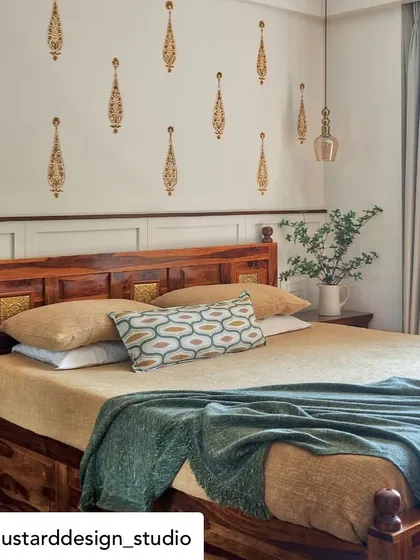 Delicate, hand-painted gold motifs on a bedroom wall, adding a touch of traditional artistry and elegance. Each brushstroke tells a story, crafting a unique and personalized atmosphere.
