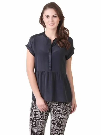 An e-commerce shoot with an international model wearing a casual black top and printed pants.