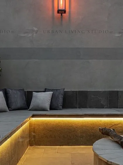Luxury is in the details. This custom-built sunken fire pit area in Aligarh, with integrated stone seating and warm LED strip lighting, creates an intimate and cozy corner for conversations on cool evenings.