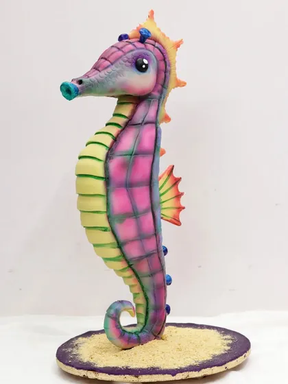 A fully sculpted and airbrushed seahorse cake, created during one of my advanced baking classes. This demonstrates the structural and artistic skills I teach.