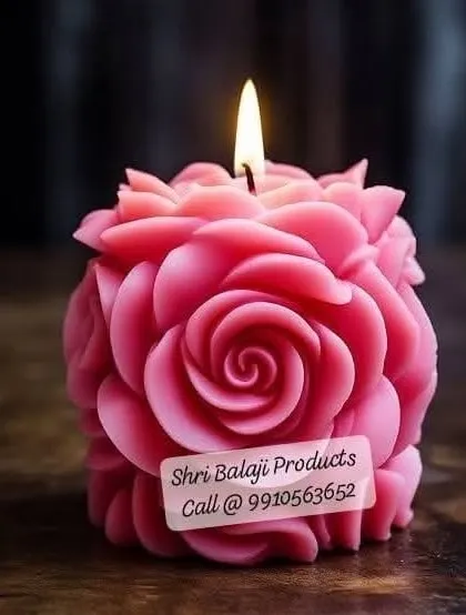 A lit rose ball candle, showcasing the beautiful, intricate layers of petals. This mold is perfect for creating a statement piece that adds a touch of romance to any setting.