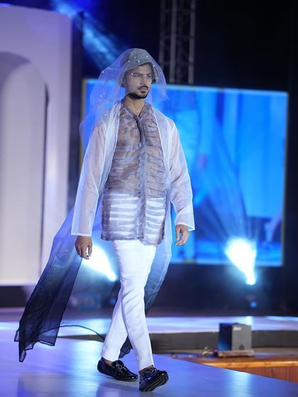 Another angle of this unique runway design, showcasing the flow and structure of the sheer, veiled garment as I walk.