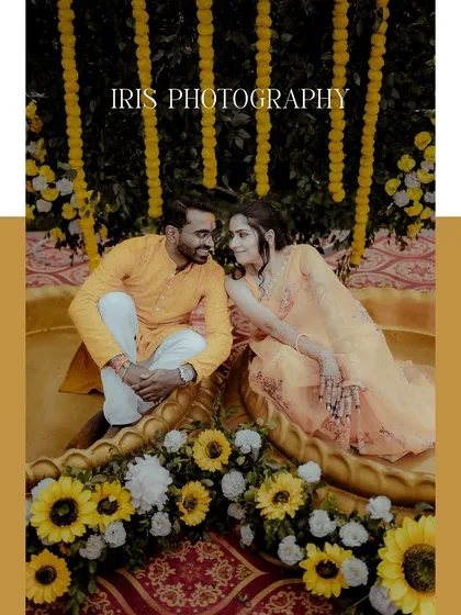 A beautiful portrait of the couple seated amidst a stunning Haldi decor of yellow flowers. This shot captures a quiet moment of connection during the celebration.