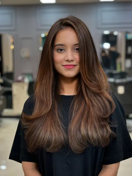 A front view of this stunning hair color. It frames her face beautifully and enhances her skin tone.