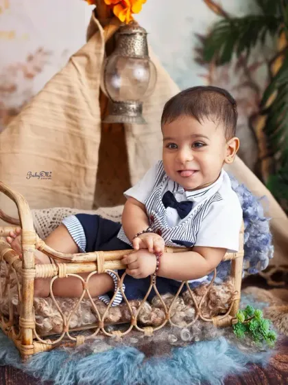 A big, happy smile from this little camper. The combination of the rustic props and his smart outfit makes for an absolutely adorable milestone photo.