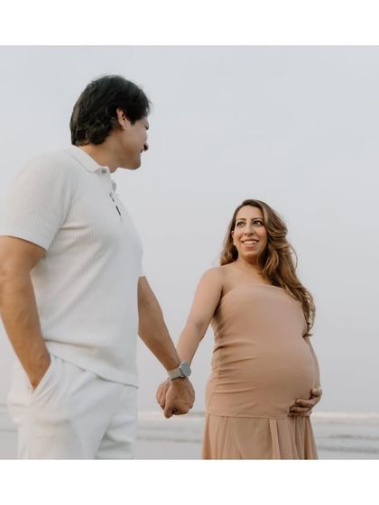 Walking along the shore, hand in hand, with the ocean witnessing their love. A beach maternity shoot is always a beautiful choice.