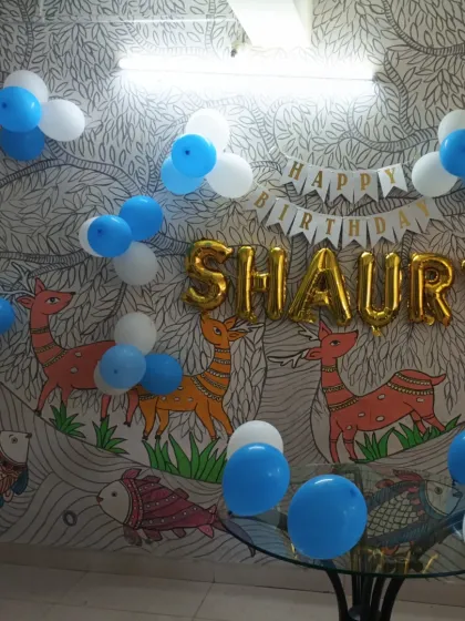 The balloon decorations complement the existing wall art in the daycare.