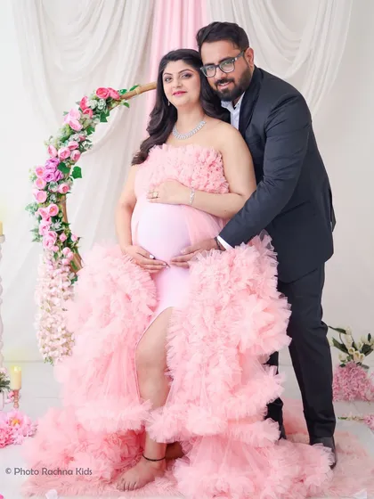 A formal and elegant portrait of the couple. The contrast between her soft pink gown and his dark suit creates a visually striking and sophisticated image.