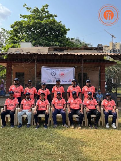 A men's team in orange jerseys sits for a team photo during a break in the PPL action.