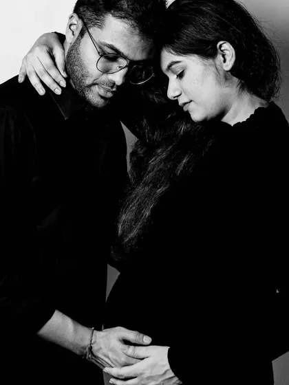 A tender black and white portrait of a couple during their maternity session. This photo captures the quiet connection and shared excitement before the baby arrives.
